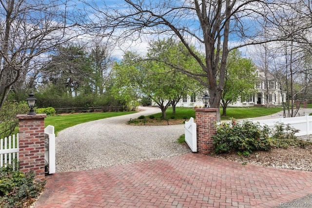 view of home's community with decorative driveway