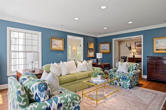 living area featuring crown molding, wood finished floors, baseboards, and recessed lighting