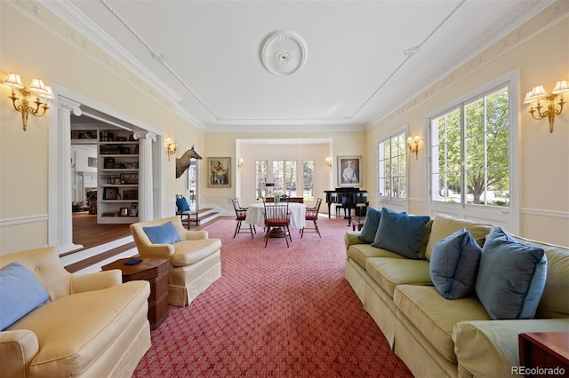 living area with crown molding and a chandelier