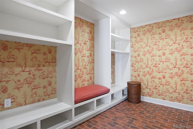mudroom with baseboards, wallpapered walls, brick patterned floors, and recessed lighting