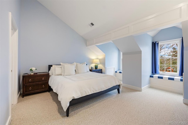 bedroom with vaulted ceiling, light carpet, and baseboards