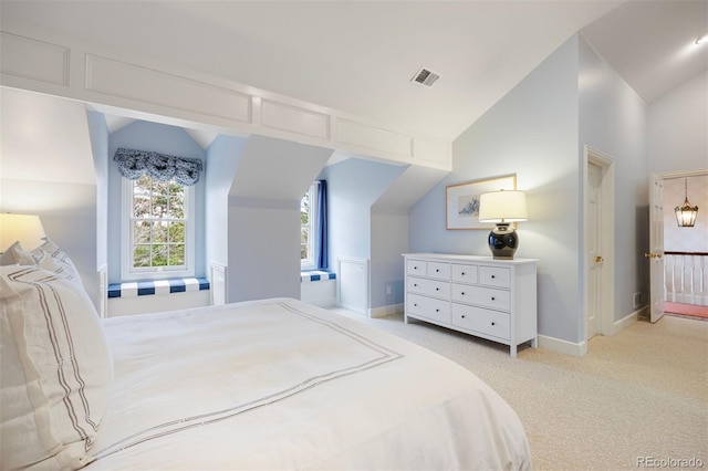 bedroom with vaulted ceiling, carpet floors, and baseboards