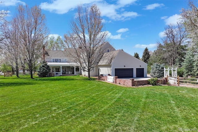 rear view of property with an attached garage and driveway