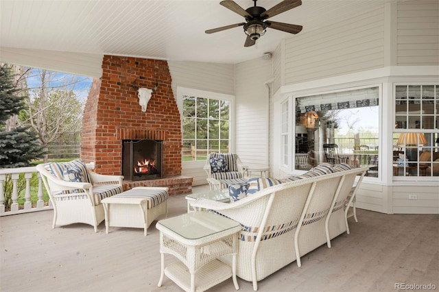 view of patio featuring an outdoor brick fireplace and ceiling fan