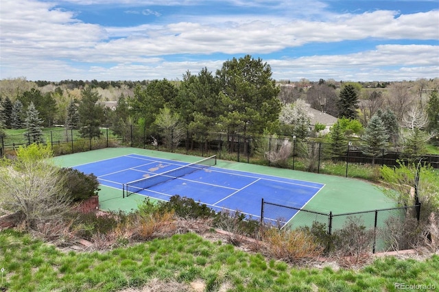 view of tennis court featuring fence