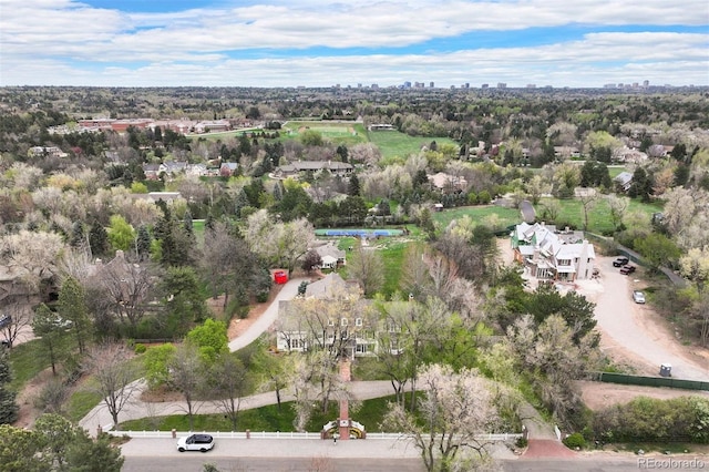 view of property location featuring a view of skyline and a tree filled landscape