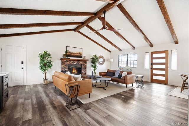 living room with beam ceiling, a fireplace, dark wood-type flooring, and ceiling fan