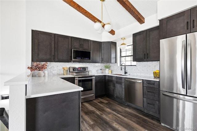 kitchen featuring tasteful backsplash, a sink, dark brown cabinets, stainless steel appliances, and dark wood-style flooring