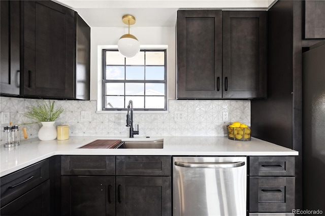 kitchen with a sink, backsplash, stainless steel dishwasher, light countertops, and dark brown cabinets