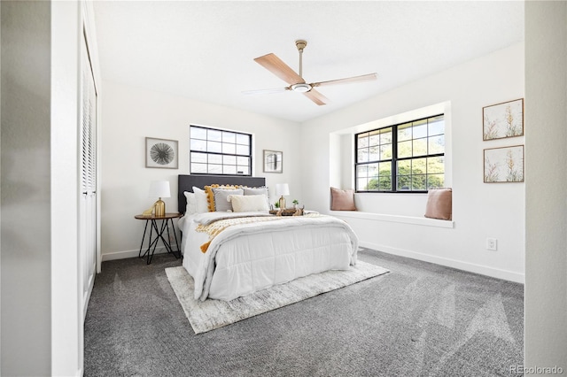 carpeted bedroom with baseboards, multiple windows, and ceiling fan