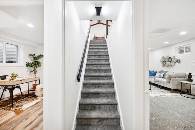 stairs with visible vents, recessed lighting, baseboards, and wood finished floors