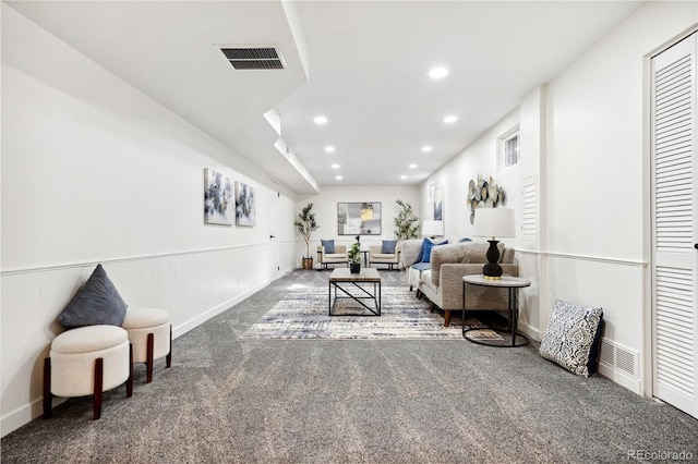 living room with recessed lighting, visible vents, a wainscoted wall, and carpet flooring