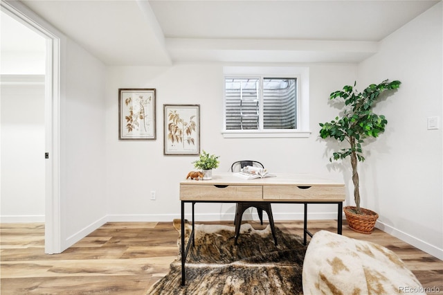 office area with baseboards and light wood-style floors