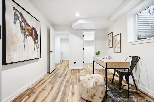 office space with baseboards and light wood-type flooring