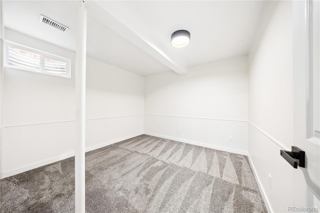 carpeted empty room featuring visible vents and baseboards