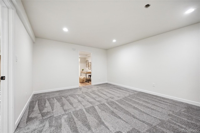 empty room with carpet flooring, recessed lighting, and baseboards