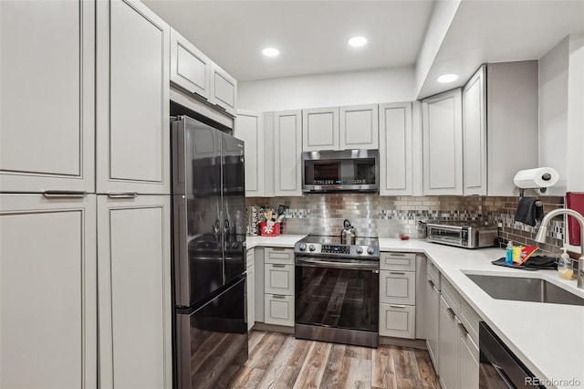 645 S Park Ave Unit 302, Breckenridge, CO 80424 - kitchen featuring appliances with stainless steel finishes, a sink, decorative backsplash, light countertops, and recessed lighting