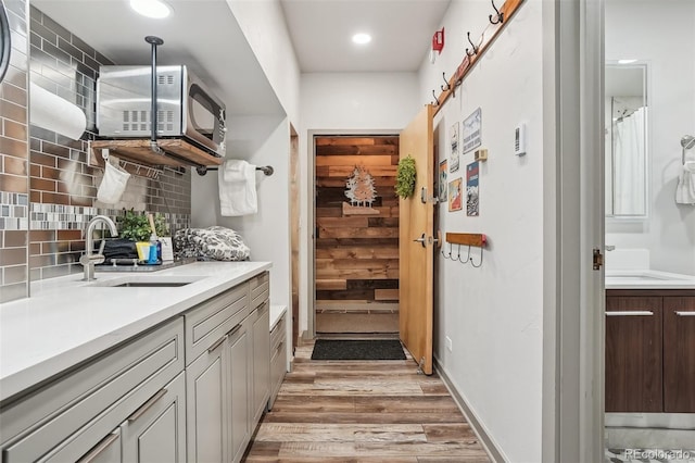 645 S Park Ave Unit 302, Breckenridge, CO 80424 - interior space with a sink, light wood-style floors, white microwave, backsplash, and recessed lighting