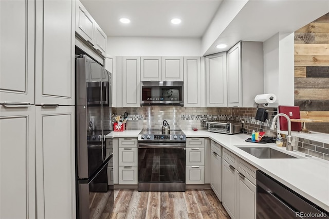 645 S Park Ave Unit 302, Breckenridge, CO 80424 - kitchen with appliances with stainless steel finishes, a sink, backsplash, light countertops, and recessed lighting