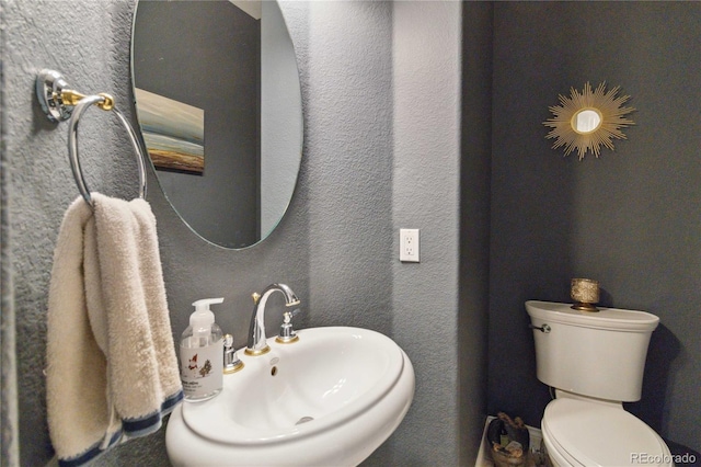 bathroom featuring a sink and toilet