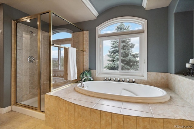 full bathroom with tile patterned flooring, a shower stall, and a garden tub