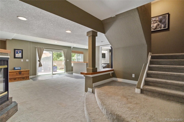 stairway featuring ornate columns, carpet, recessed lighting, baseboards, and a textured ceiling