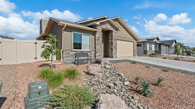 681 Eadin Ln, Grand Junction, CO 81504 - view of front of home with stone siding, driveway, a garage, stucco siding, and a residential view