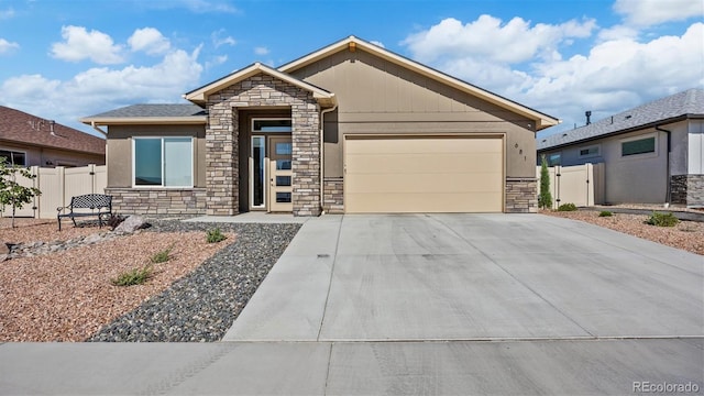 681 Eadin Ln, Grand Junction, CO 81504 - ranch-style house with stone siding, a garage, driveway, and stucco siding