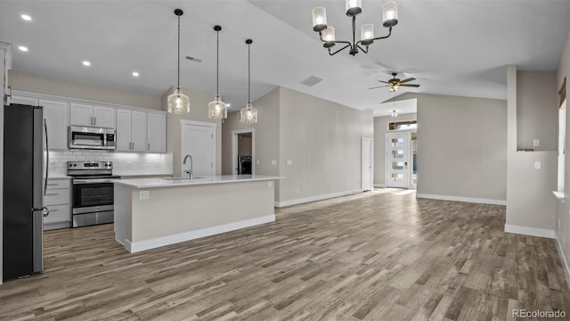 681 Eadin Ln, Grand Junction, CO 81504 - kitchen with stainless steel appliances, open floor plan, wood finished floors, recessed lighting, and vaulted ceiling