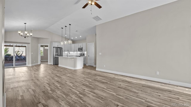 681 Eadin Ln, Grand Junction, CO 81504 - unfurnished living room featuring a chandelier, light wood finished floors, ceiling fan, and high vaulted ceiling
