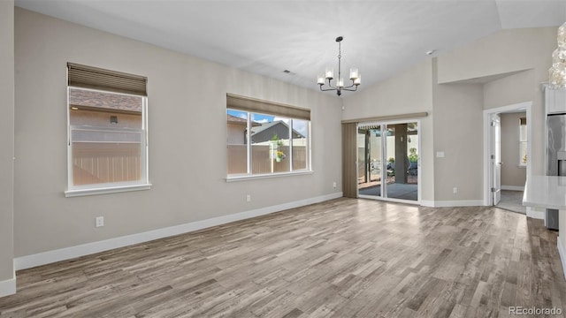 681 Eadin Ln, Grand Junction, CO 81504 - unfurnished room featuring a chandelier, wood finished floors, vaulted ceiling, and french doors