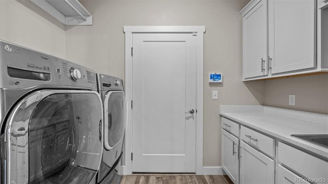 681 Eadin Ln, Grand Junction, CO 81504 - laundry room featuring washing machine and clothes dryer, cabinet space, and wood finished floors