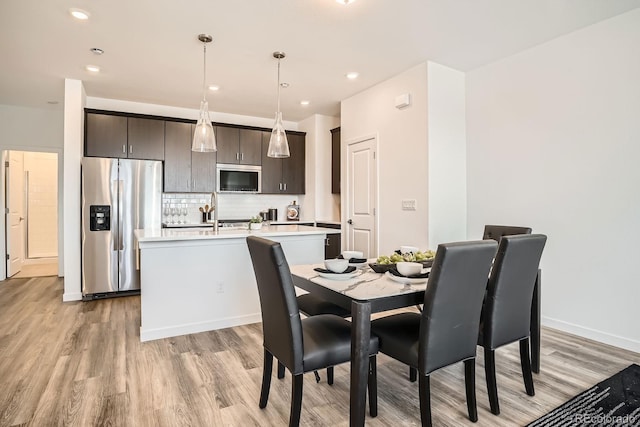 370 Geneva St, Aurora, CO 80010 - dining space featuring light wood-style flooring and recessed lighting