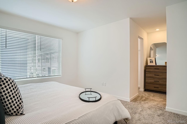 370 Geneva St, Aurora, CO 80010 - carpeted bedroom with baseboards and arched walkways