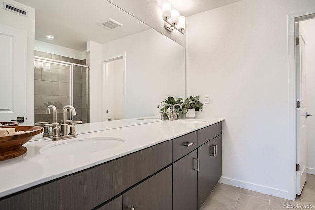 370 Geneva St, Aurora, CO 80010 - bathroom with double vanity, a stall shower, and tile patterned flooring