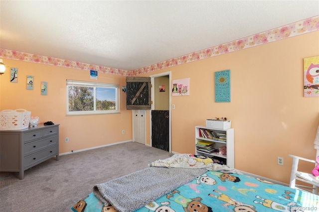 carpeted bedroom with baseboards and a textured ceiling