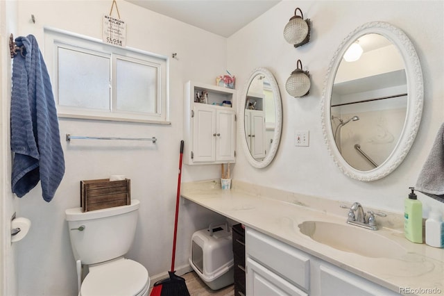 bathroom featuring toilet and vanity