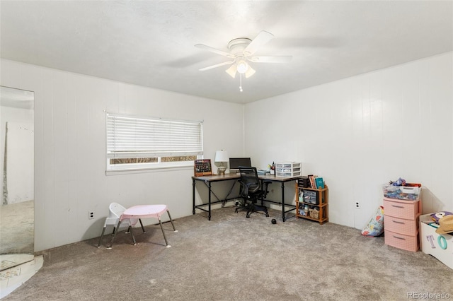 carpeted office space with ceiling fan