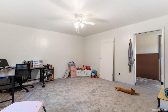 carpeted home office with ceiling fan