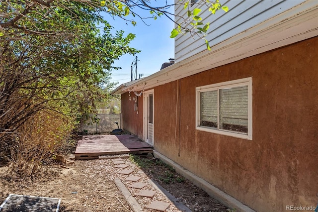 view of side of home featuring a wooden deck