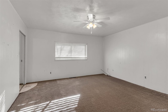 spare room featuring carpet flooring and ceiling fan