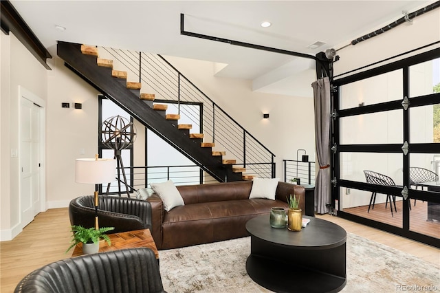 living room with visible vents, wood finished floors, recessed lighting, stairway, and baseboards