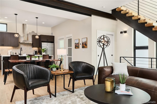 living room featuring stairway, recessed lighting, and light wood-style floors