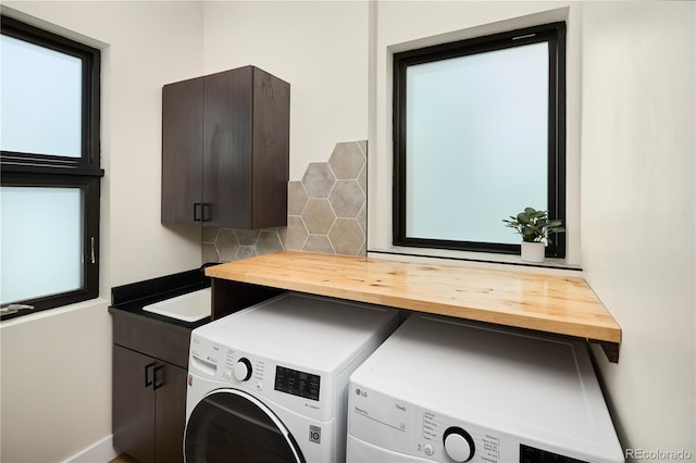 laundry room featuring washer and dryer and cabinet space