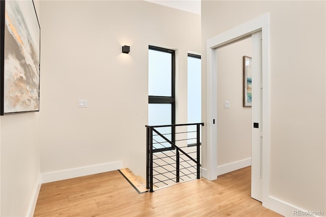 foyer entrance with baseboards and light wood finished floors