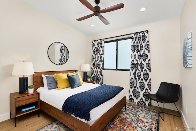 bedroom with a ceiling fan, wood finished floors, recessed lighting, baseboards, and vaulted ceiling