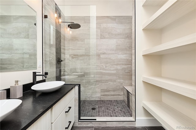 full bath featuring double vanity, walk in shower, and a sink