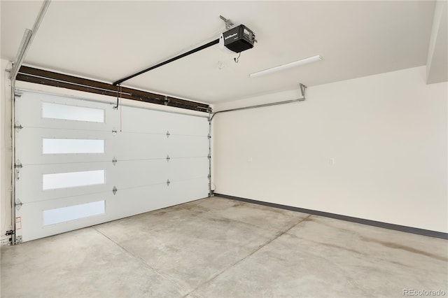 garage featuring a garage door opener and baseboards