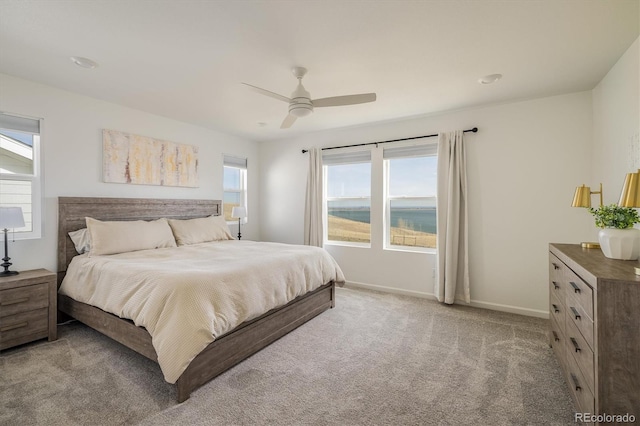16568 W 92nd Pl, Arvada, CO 80007 - bedroom featuring light carpet, multiple windows, and ceiling fan