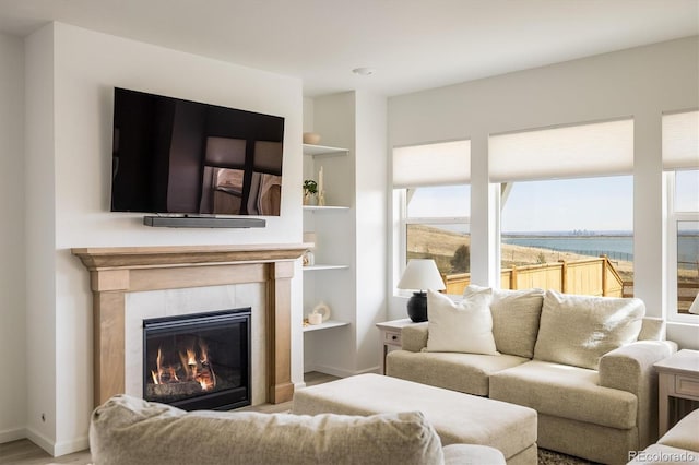 16568 W 92nd Pl, Arvada, CO 80007 - living area with a tiled fireplace, built in shelves, and wood finished floors